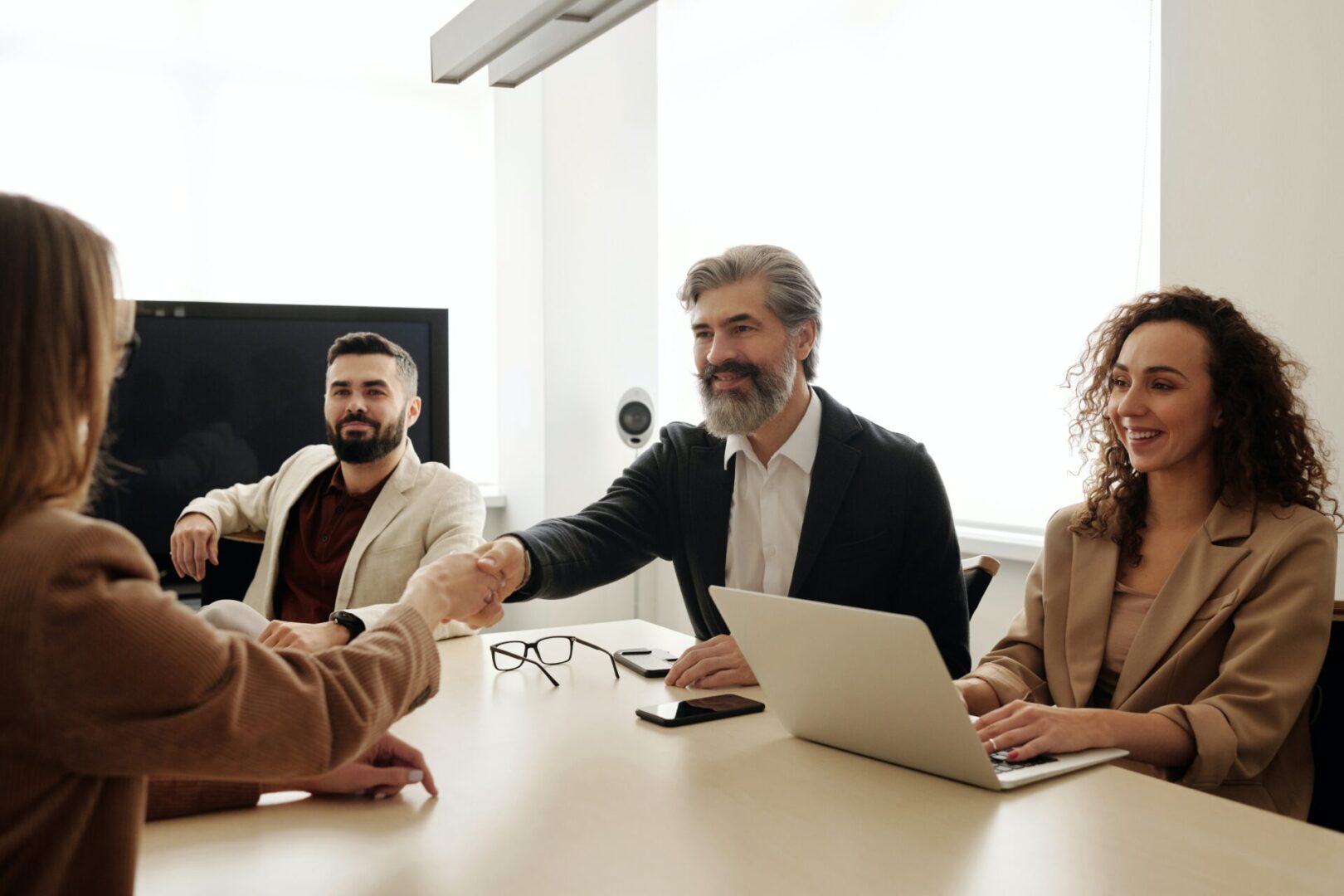 Group of happy people shaking hands